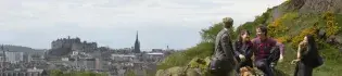 Students pictured on Arthurs Seat, Edinburgh, with the Edinburgh old town and castle in the background.